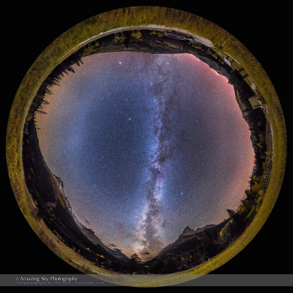 This is the Milky Way of the autumn season in the Northern Hemisphere, on a late September night, from the very dark site of Red Rock Canyon, in Waterton Lakes National Park, Canada. The scene is a 360° panorama taking in the entire sky, taken about 11:00 pm. Illumination is solely by starlight. Being autumn, the larches and aspens are in autumn colours. Snow is on Mount Blakiston at left, while the sharp peak at right is Anderson Peak. The galactic centre is toward the southwest at bottom, though Sagittarius itself had set by the time I shot this panorama. The bright star cloud of Scutum is above the mountains. The Milky Way stretches up through Aquila, through the Summer Triangle stars, with the Cygnus starcloud below centre. At centre is the dark nebula known as the Funnel Nebula. Above it, and above centre, the Milky Way continues through Cepheus, Cassiopeia, and into Perseus. The stars of Auriga and Taurus are just rising in the northeast at top. The Andromeda Galaxy is the fuzzy spot at left of centre. The Pleiades are above the mountains at top left. The dark lanes along the Milky Way are obvious, and with differing densities and opacities. At left is the faint Zodiacal Band, and the brighter diffuse glow of the Gegenschein, in Pisces at this time of year. This glow is always at the point in the sky opposite the Sun, where cometary dust particles reflect sunlight directly back to Earth. To the right the sky is colored red by a dim aurora to the north, and by airglow. My other camera is in the scene, shooting a time-lapse of the Milky Way motion. This is a multi-tier panorama, consisting of 48 segments (!), in 4 tiers of 12 segments each, taken with the iPano motorized panning unit. Each exposure was 30 seconds at f/2 with the 24mm lens and Canon 6D at ISO 6400. Stitching was with PTGui, which did it flawlessly. The original image is 12,000 x 12,000 pixels.