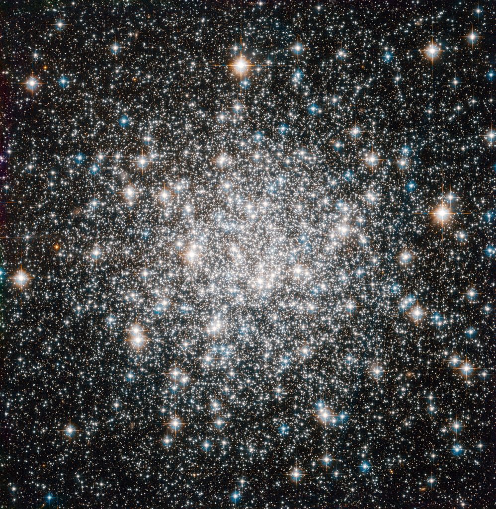 The NASA/ESA Hubble Space Telescope offers this delightful view of the crowded stellar encampment called Messier 68, a spherical, star-filled region of space known as a globular cluster. Mutual gravitational attraction amongst a cluster’s hundreds of thousands or even millions of stars keeps stellar members in check, allowing globular clusters to hang together for many billions of years. Astronomers can measure the ages of globular clusters by looking at the light of their constituent stars. The chemical elements leave signatures in this light, and the starlight reveals that globular clusters' stars typically contain fewer heavy elements, such as carbon, oxygen and iron, than stars like the Sun. Since successive generations of stars gradually create these elements through nuclear fusion, stars having fewer of them are relics of earlier epochs in the Universe. Indeed, the stars in globular clusters rank among the oldest on record, dating back more than 10 billion years. More than 150 of these objects surround our Milky Way galaxy. On a galactic scale, globular clusters are indeed not all that big. In Messier 68's case, its constituent stars span a volume of space with a diameter of little more than a hundred light-years. The disc of the Milky Way, on the other hand, extends over some 100 000 light-years or more. Messier 68 is located about 33 000 light-years from Earth in the constellation Hydra (The Female Water Snake). French astronomer Charles Messier notched the object as the sixty-eighth entry in his famous catalogue in 1780. Hubble added Messier 68 to its own impressive list of cosmic targets in this image using the Wide Field Camera of Hubble’s Advanced Camera for Surveys. The image, which combines visible and infrared light, has a field of view of approximately 3.4 by 3.4 arcminutes.